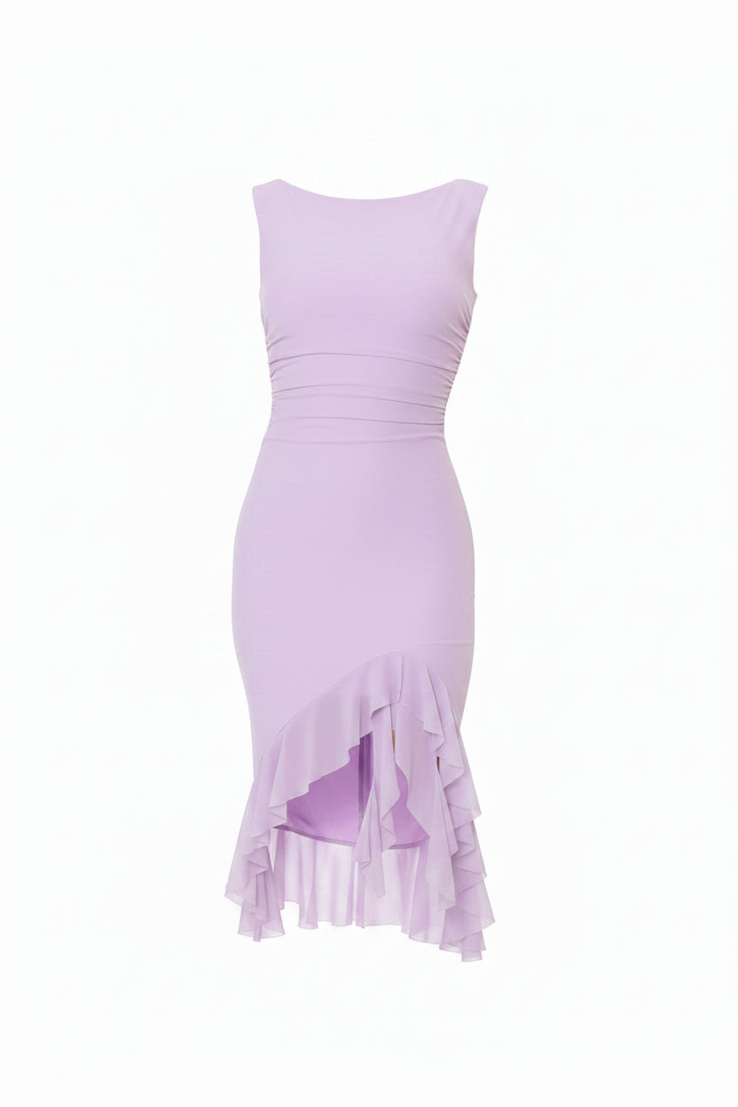 Woman wearing a light purple dress with ruffled hem against a stone wall.